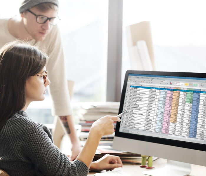 An IT Manager working through spreadsheet